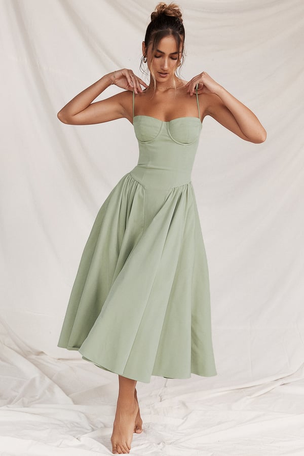 Montaracrest midi pleated dress with structured bodice and side pockets, shown in the image.