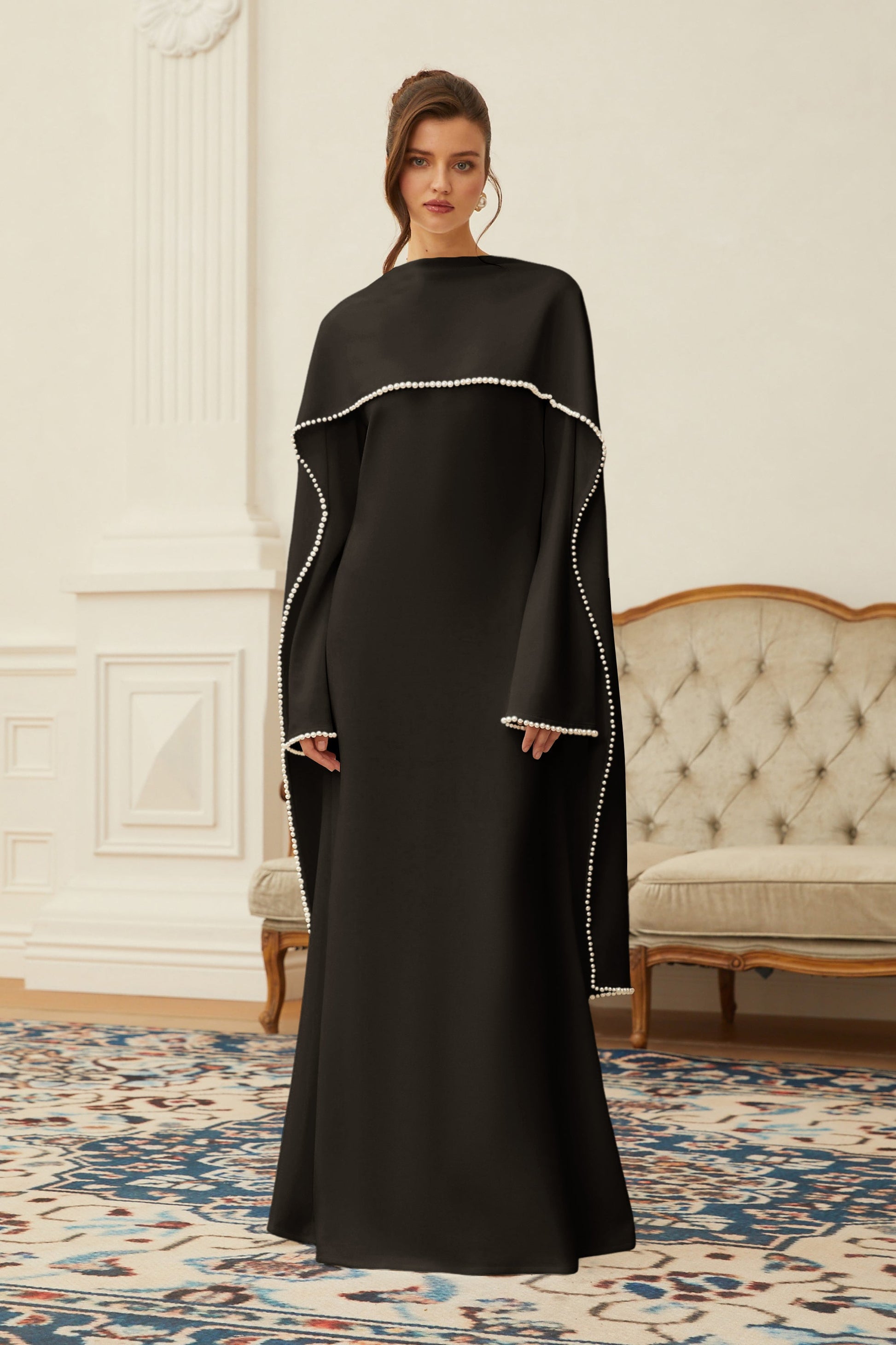 Montaracrest Piroska black maxi dress featuring pearl trim and shawl detail, elegant evening wear with flowing fabric.