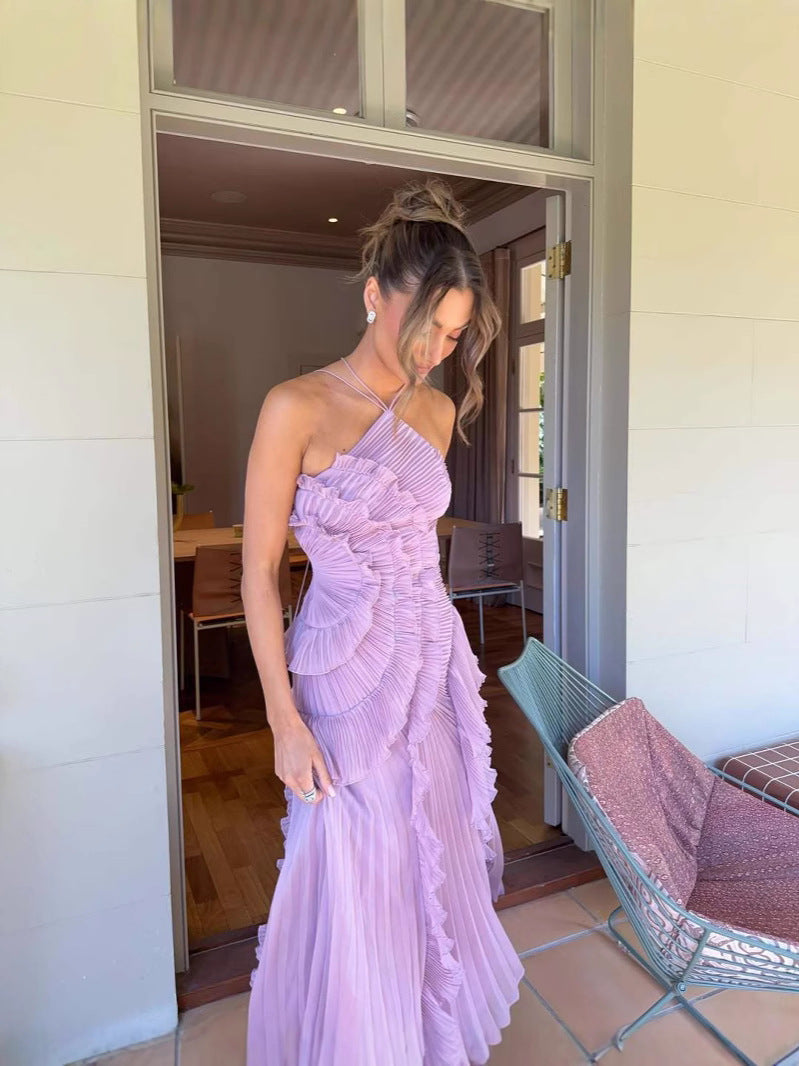 Elegant long pleated dress by Montaracrest with halter neckline and ruffle details, showcased on a mannequin.