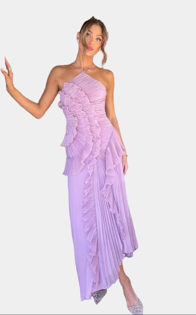 Elegant long pleated dress by Montaracrest featuring a halter neckline and ruffle details, shown on a model.
