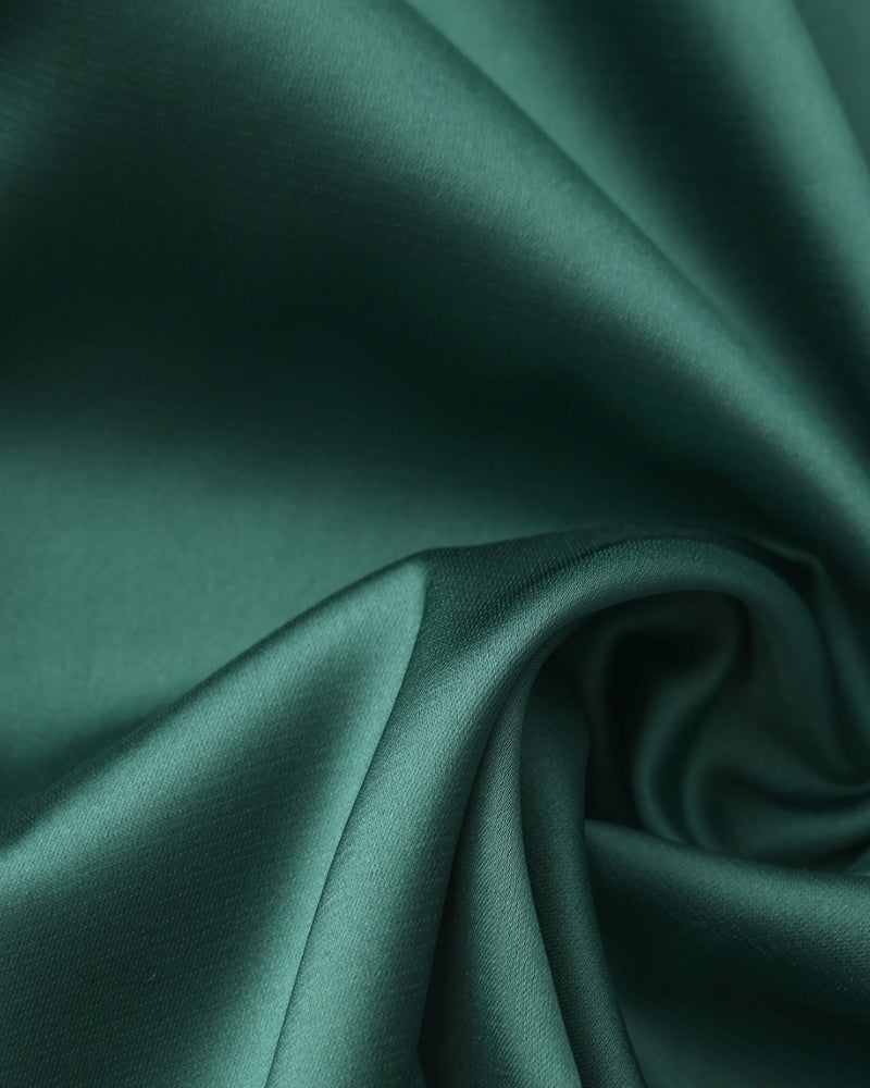 Silk slip dress by Montaracrest with elegant drape, featuring a smooth, luxurious fabric in a sleek, minimalist design.