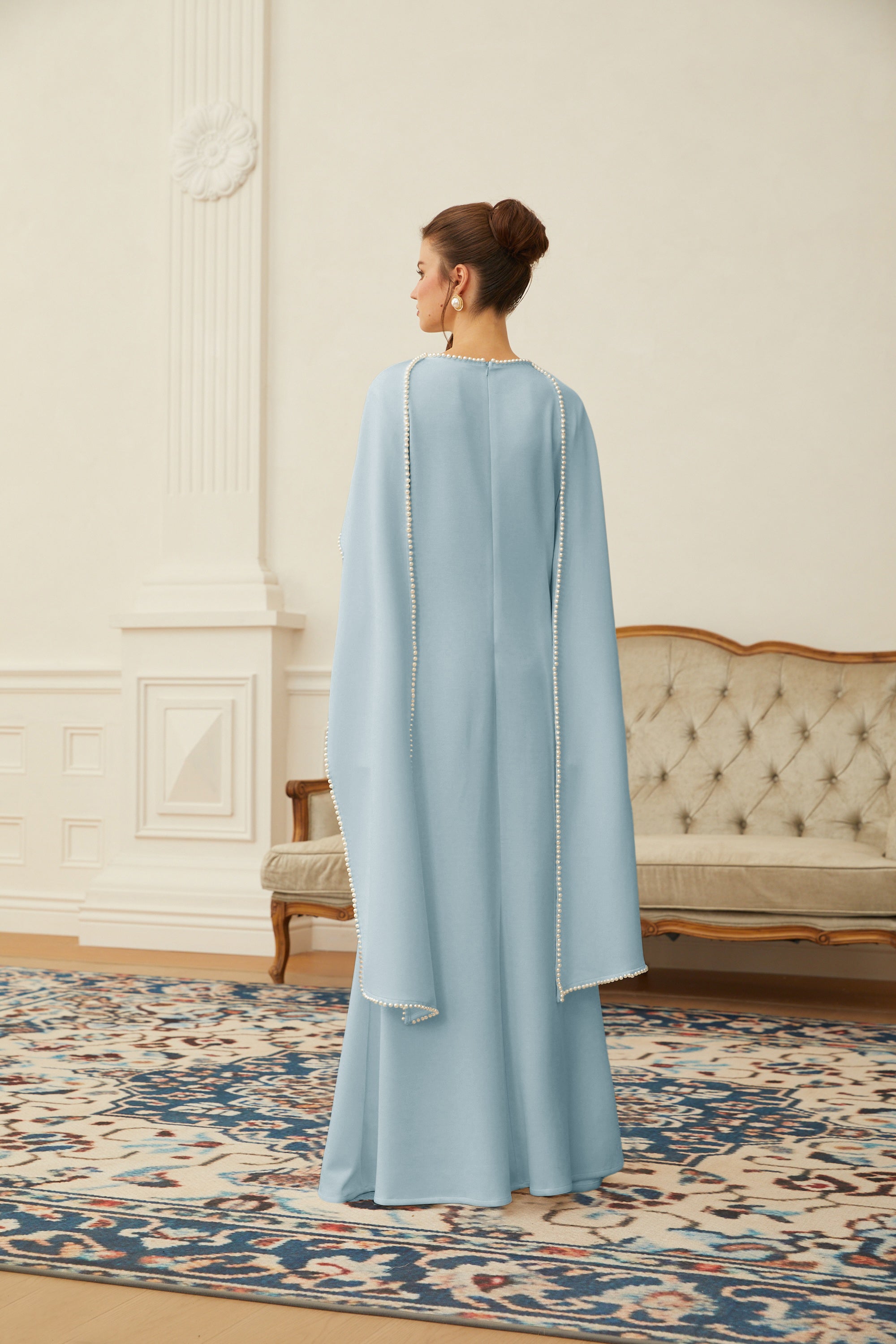 Montaracrest Piroska Blue Pearl Trim Shawl Maxi Dress featuring elegant blue fabric and intricate pearl detailing.
