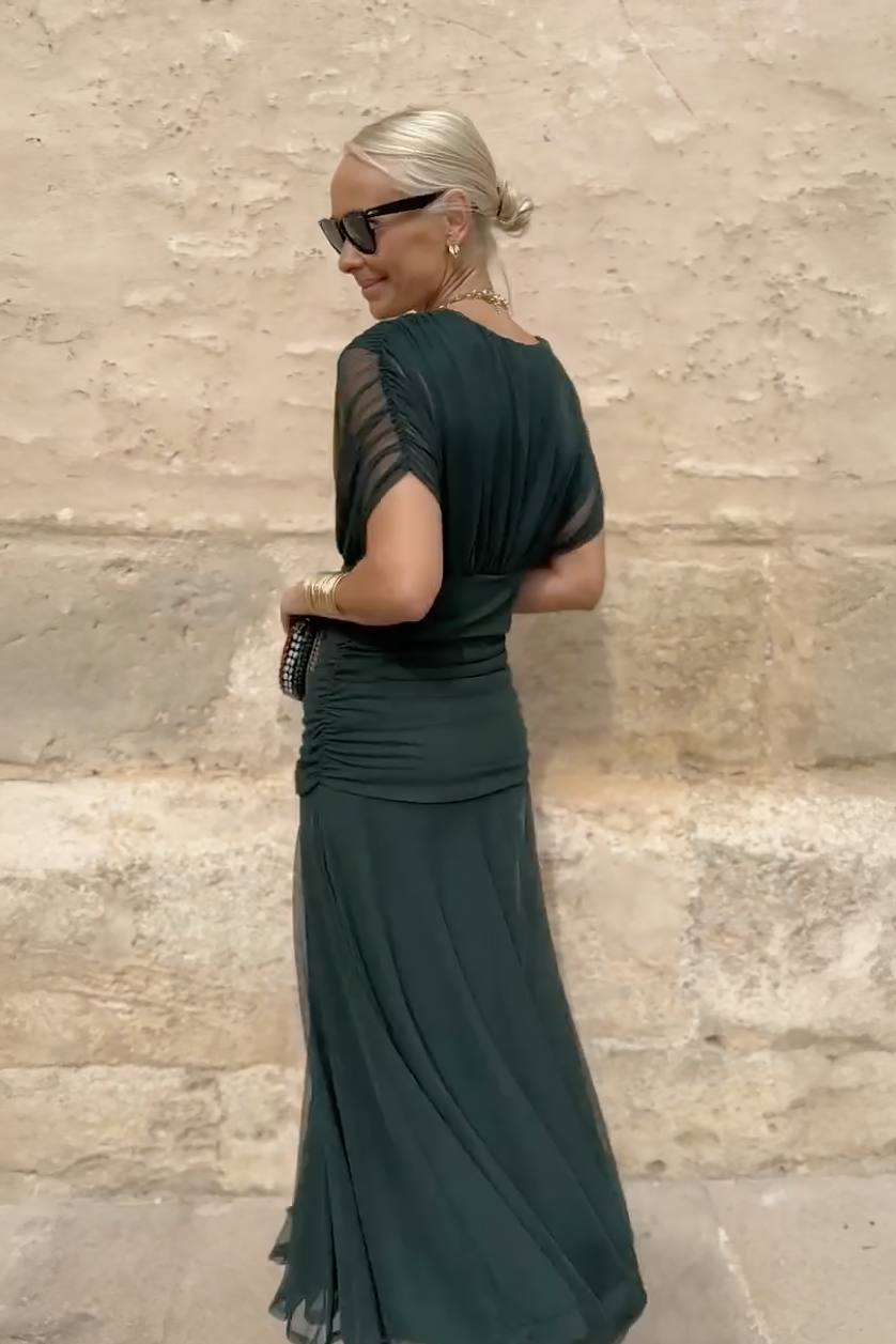 Elegant long dress by Montaracrest featuring a V-neckline that enhances the silhouette, suitable for formal occasions.