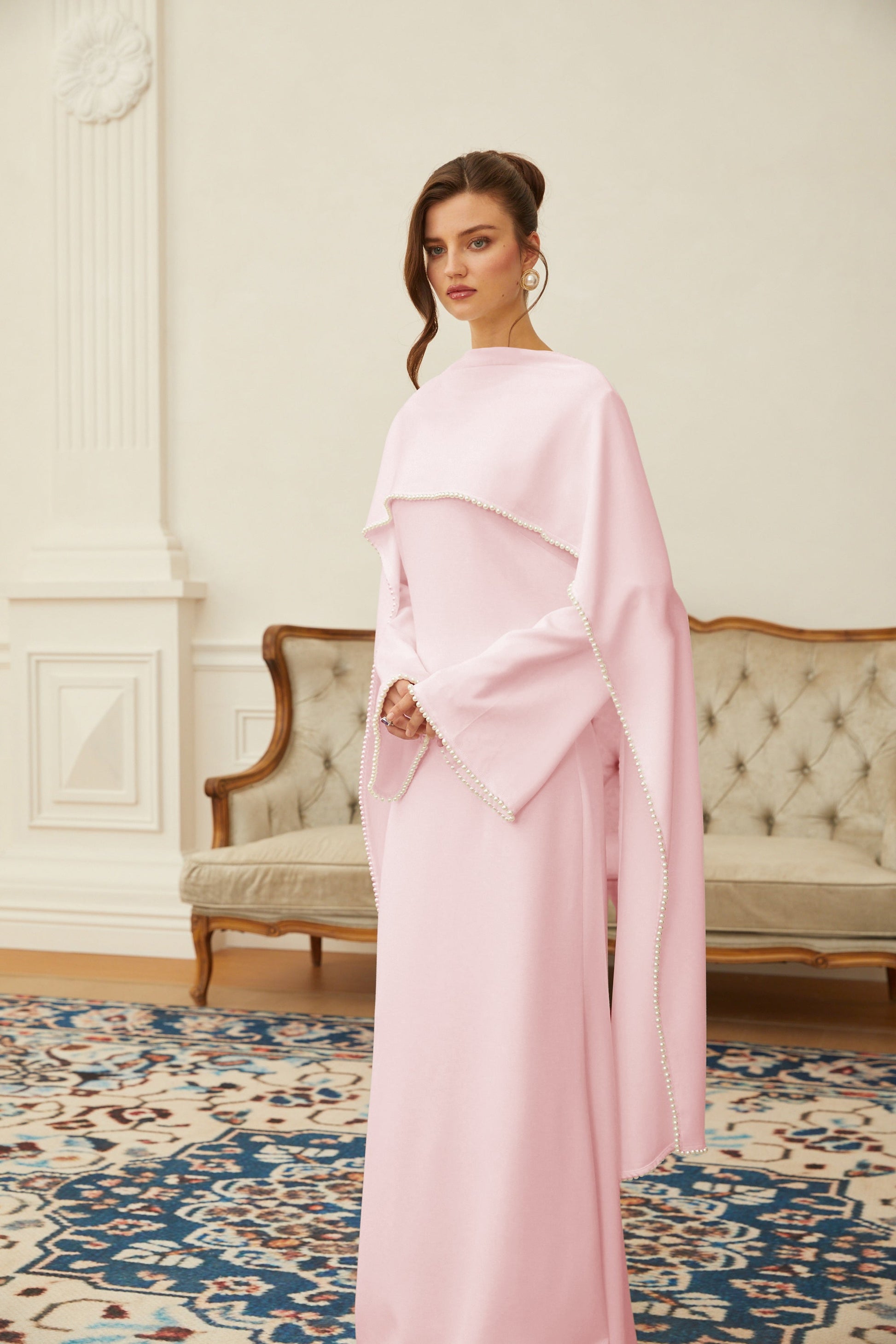 Pink maxi dress by Montaracrest featuring pearl trim and shawl detail, flowing fabric and elegant design for formal occasions.