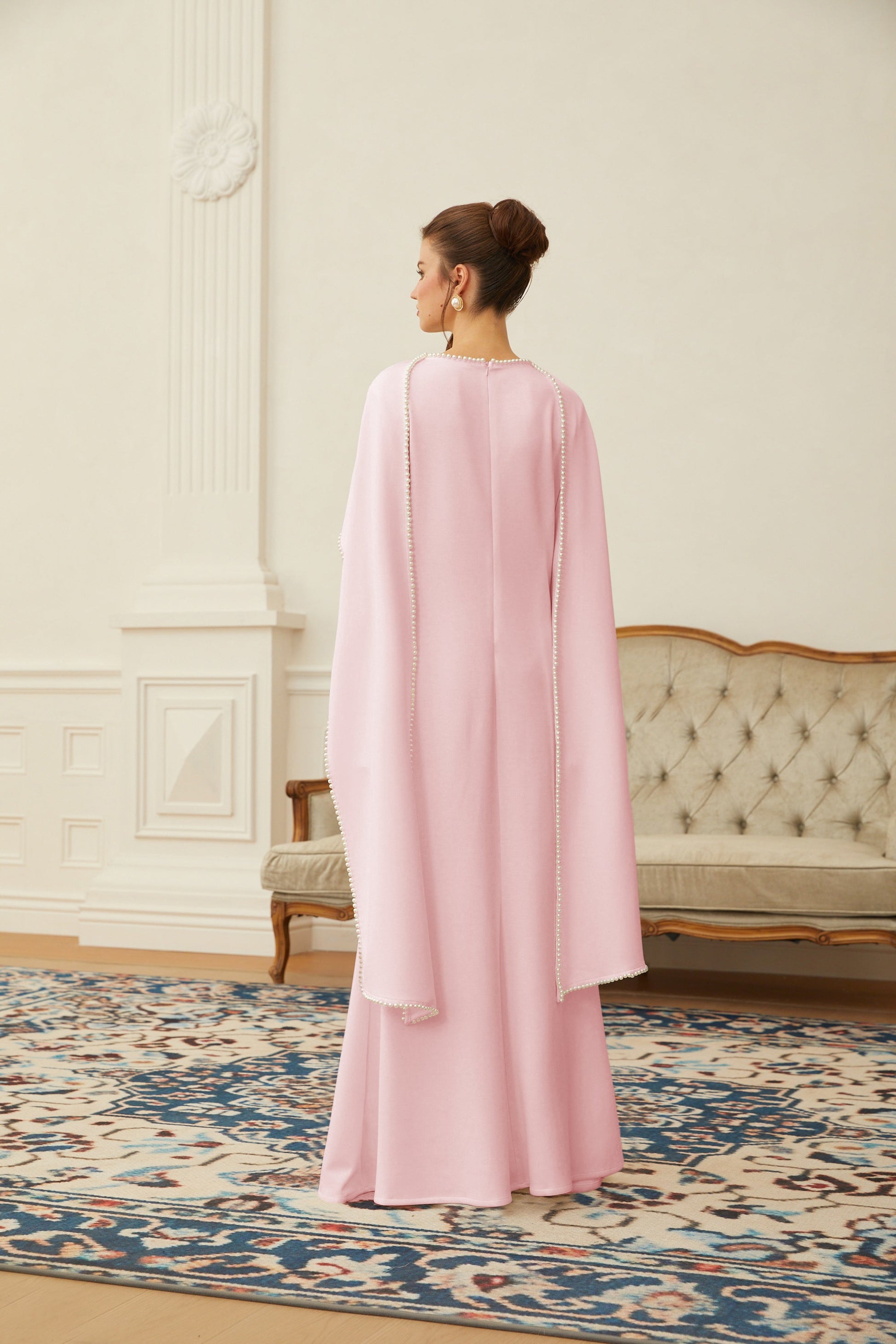 Pink maxi dress with pearl trim shawl detail from Montaracrest, featuring a flowing fabric and elegant design.