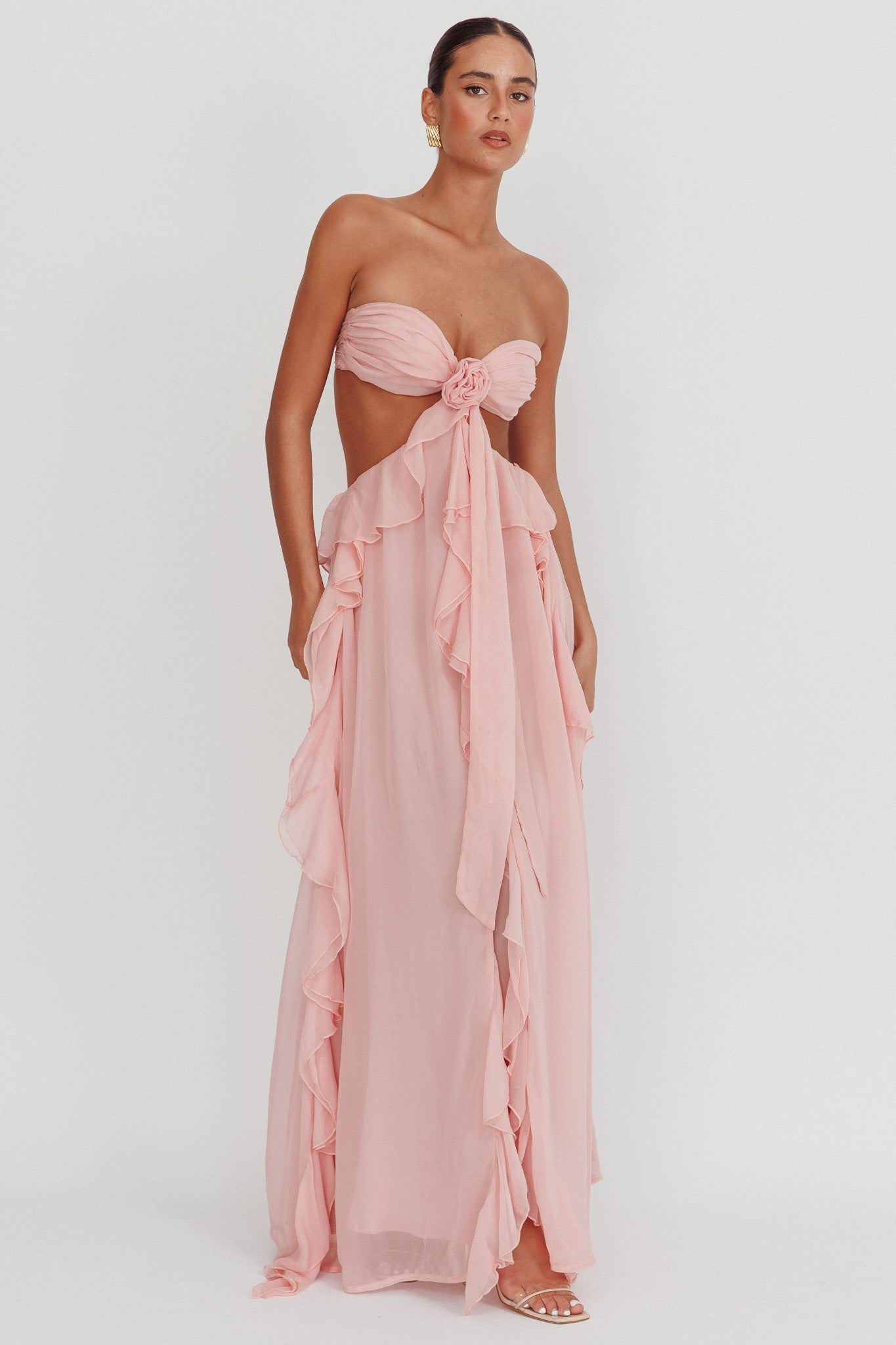 Montaracrest long sleeveless dress with cut-out details and flowing ruffle accents, perfect for elegant summer occasions.
