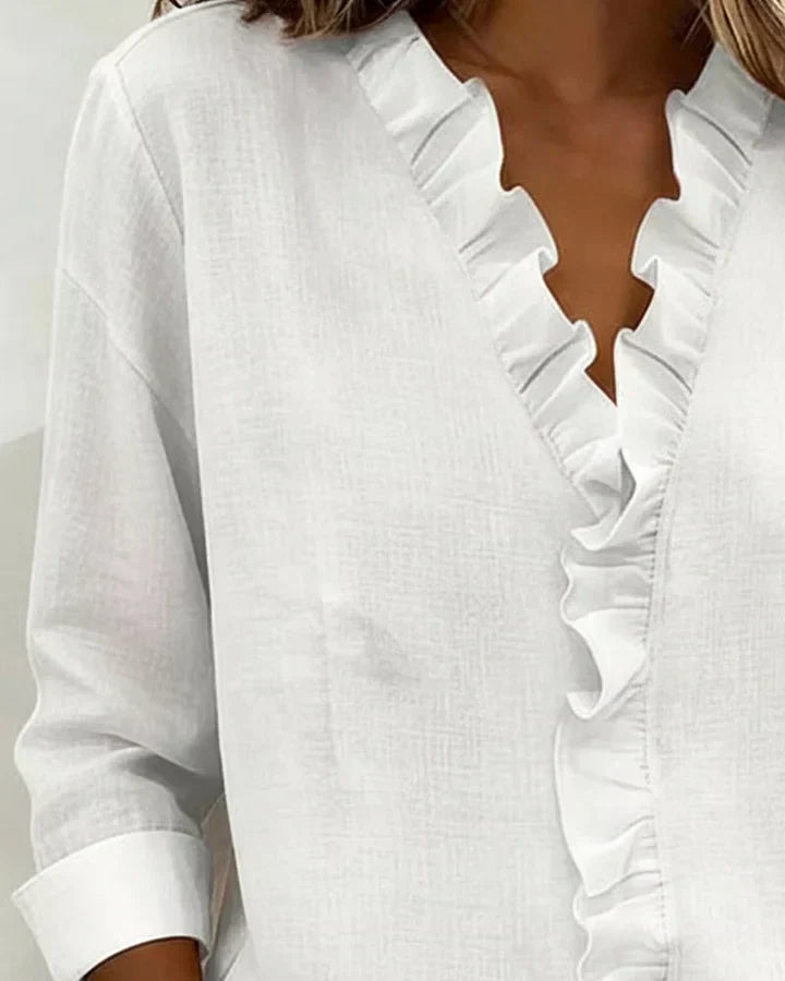 Montaracrest Chiara V-neck blouse with delicate ruffled accents, lightweight fabric, and stylish design for elegant everyday wear.