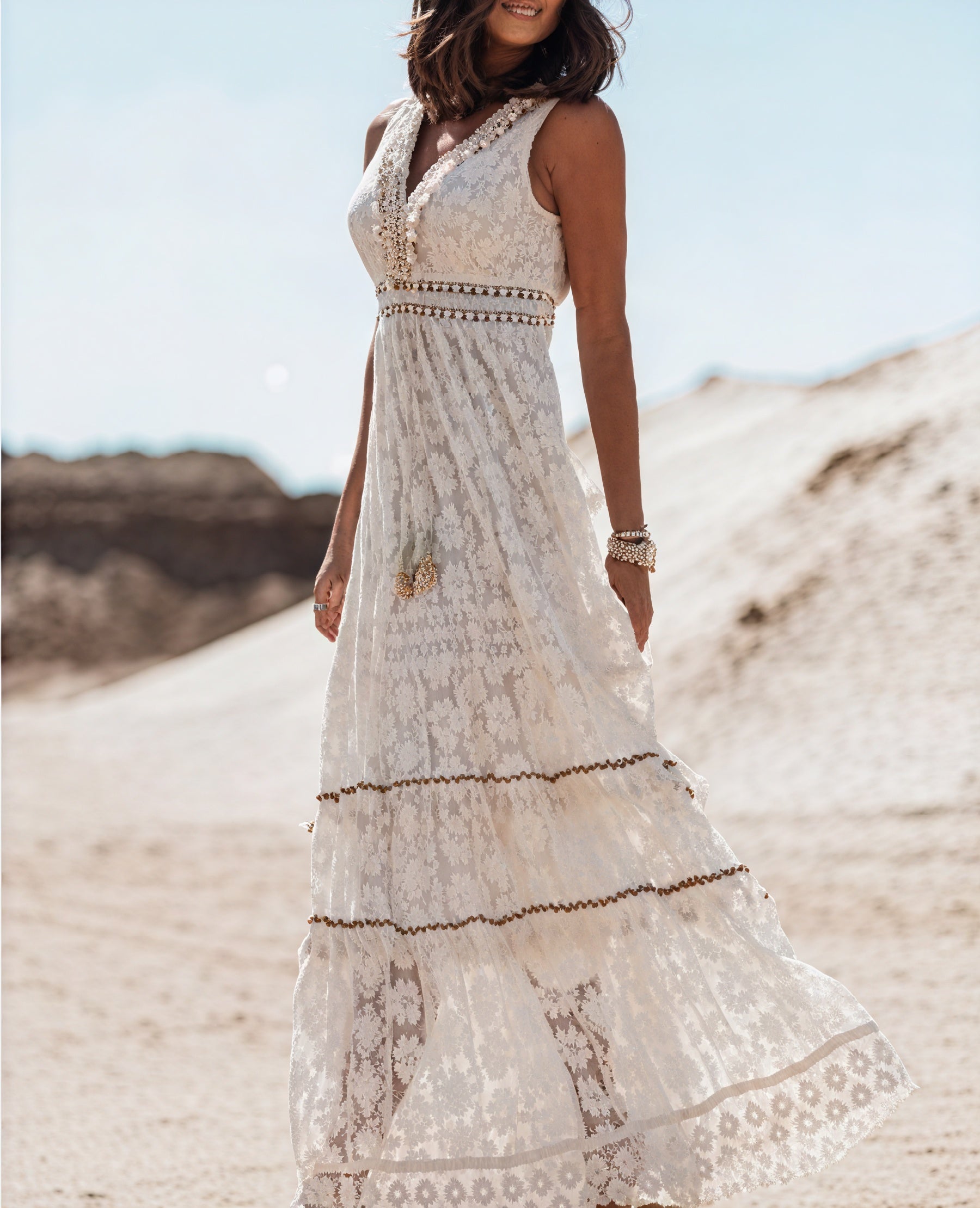 Elegant white lace midi dress with romantic detailing from Montaracrest, featuring intricate lace patterns and a fitted silhouette.
