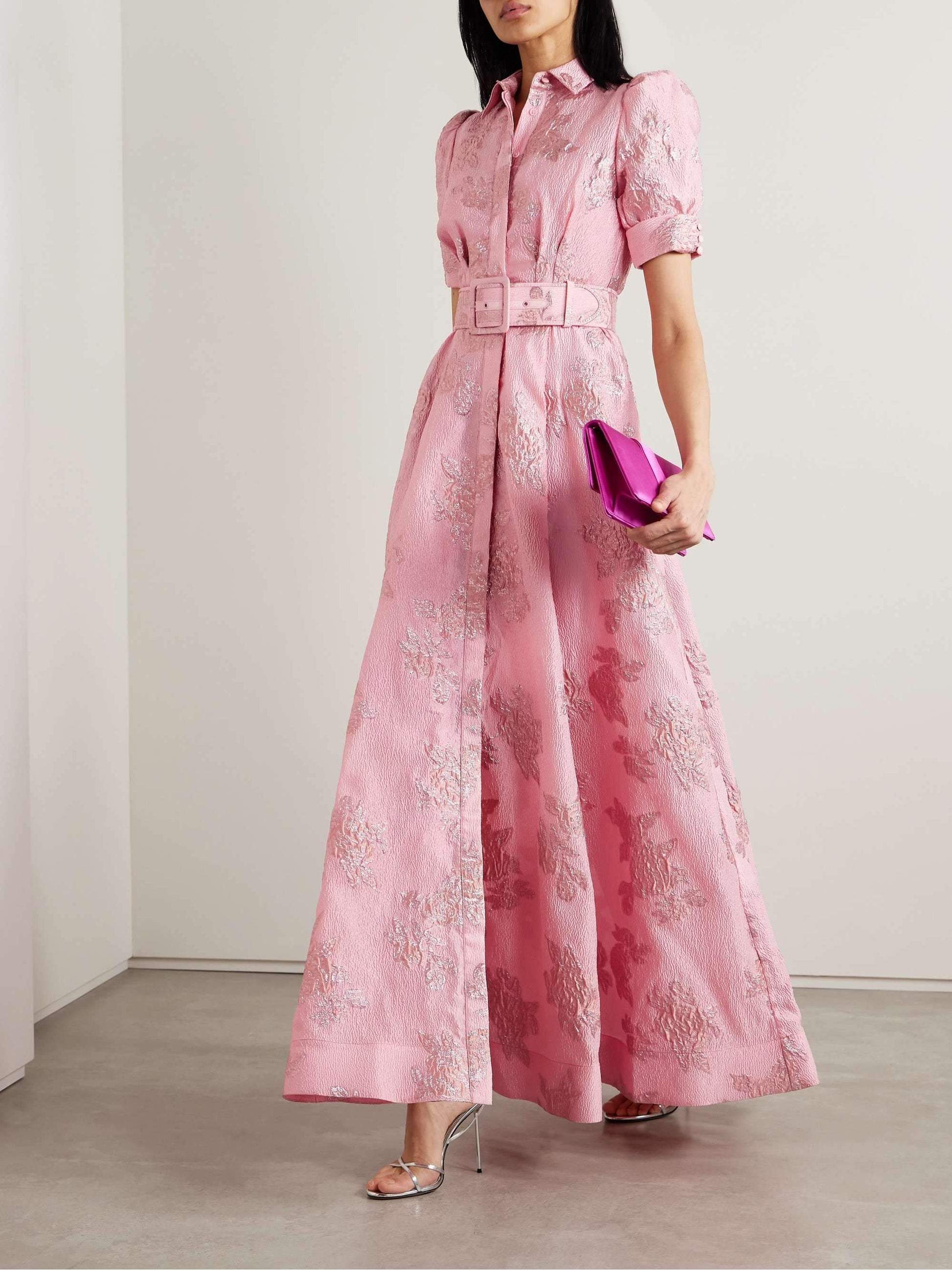 Elegant long dress with waist belt by Montaracrest, featuring flowing fabric and sophisticated design for timeless style.