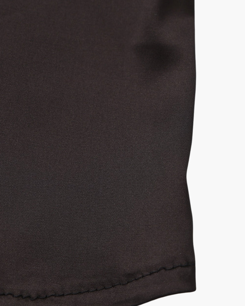 Elegant Ravelli Milano silk slip dress in soft, flowing fabric with delicate straps, designed for a sophisticated look.