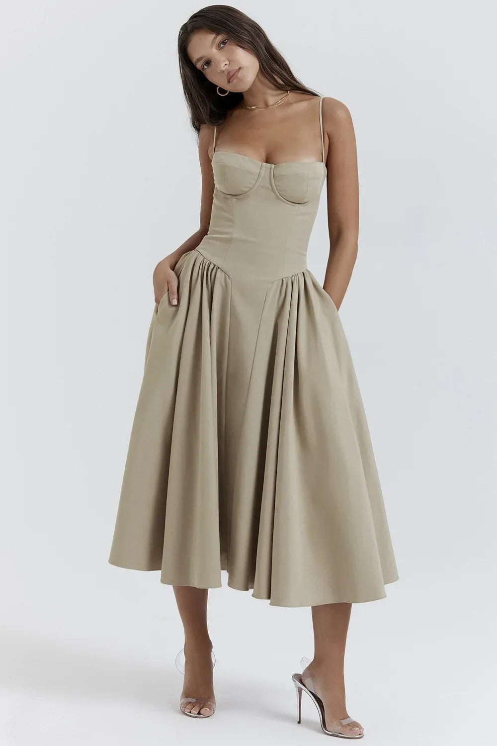 Midi pleated dress by Montaracrest featuring a structured bust, side pockets, and elegant design.