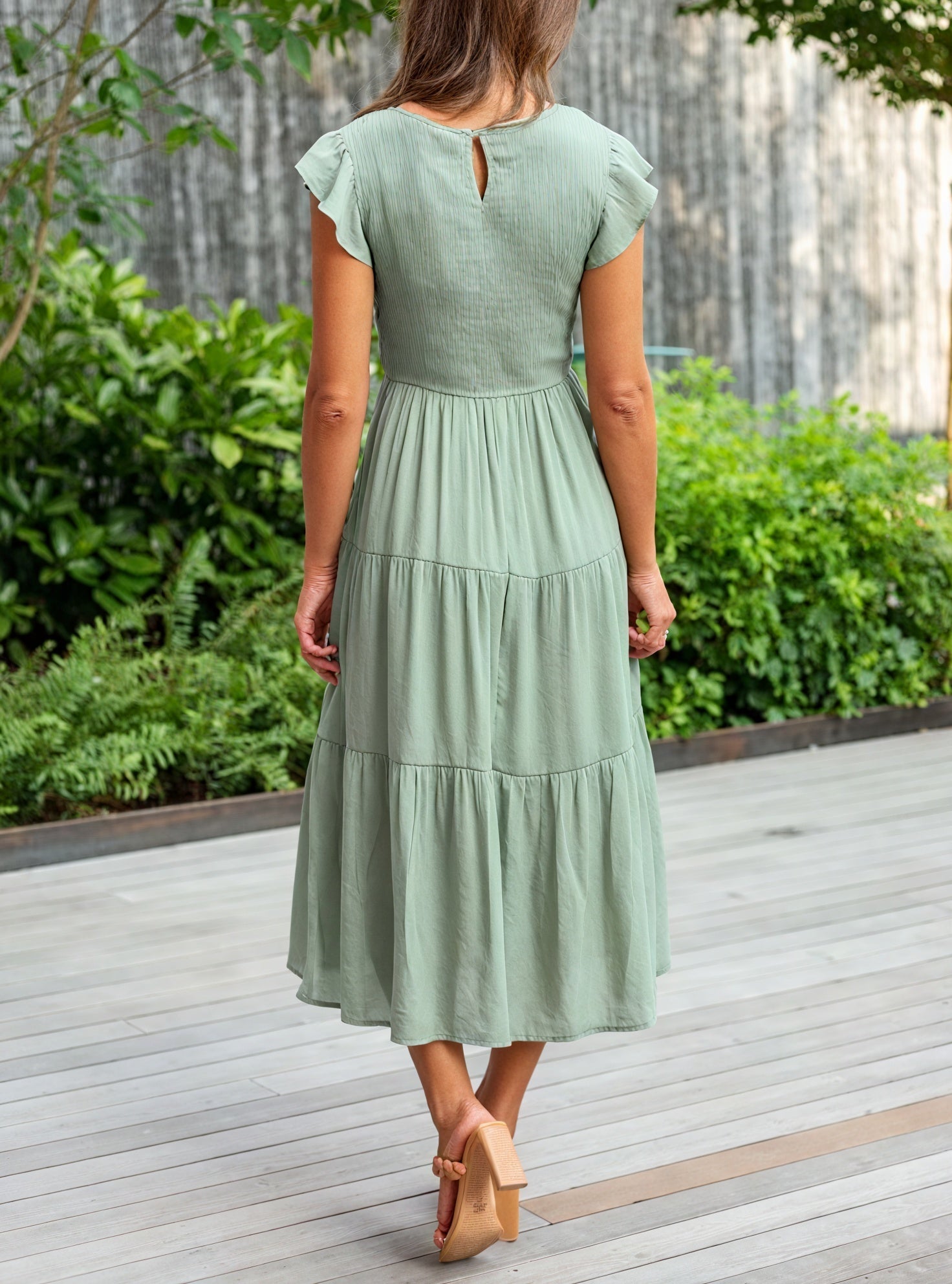 Fluid chiffon dress with ruffled sleeves and voluminous fabric, stylishly designed by Montaracrest.