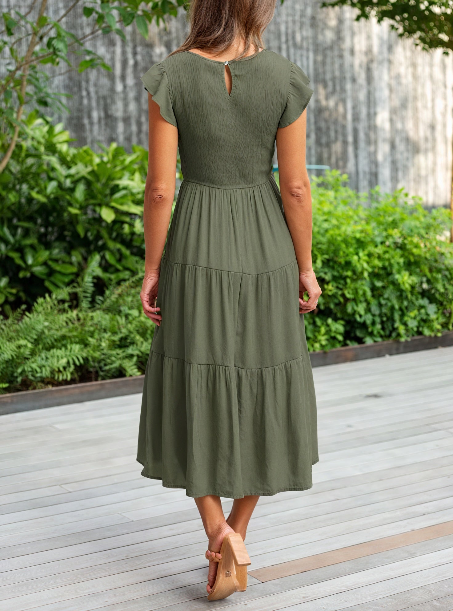 Fluid ruffled dress with flutter sleeves by Montaracrest, featuring a flowing silhouette and delicate fabric details.