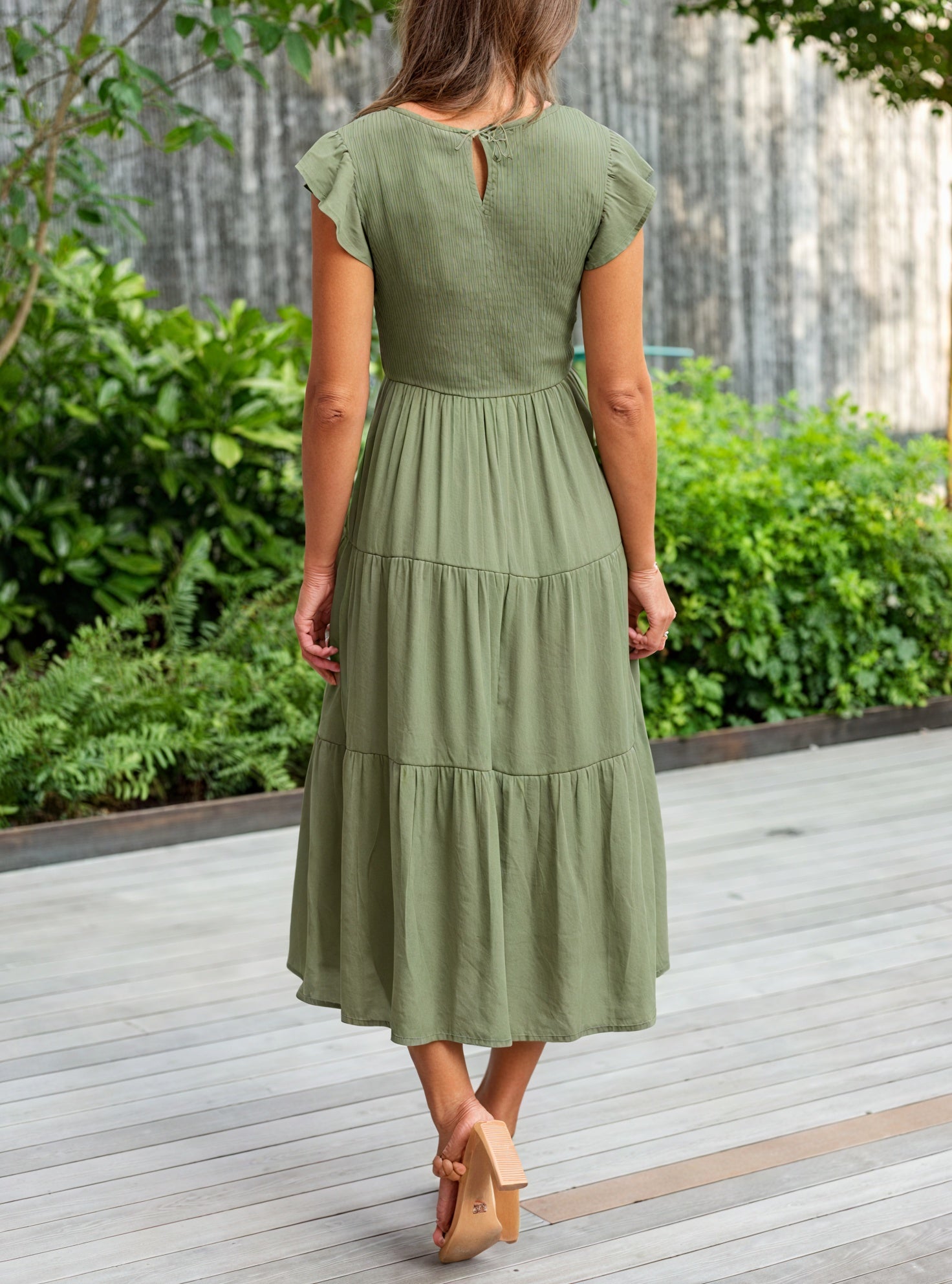 Fluid chiffon dress with ruffle sleeves and cascading flounces, stylishly designed by Montaracrest.