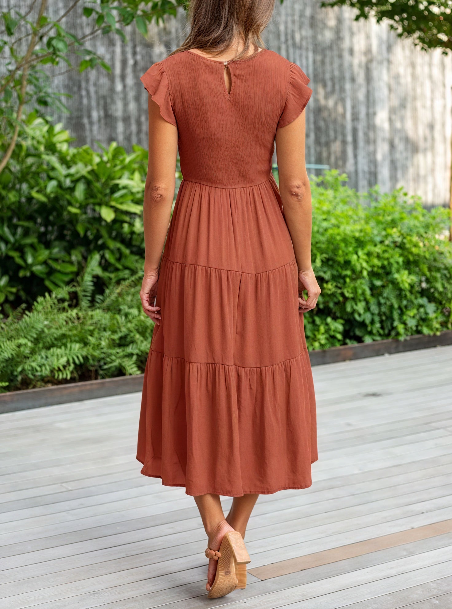 Fluid chiffon dress with ruffled voluminous sleeves and layered flared skirts, stylishly designed by Montaracrest.