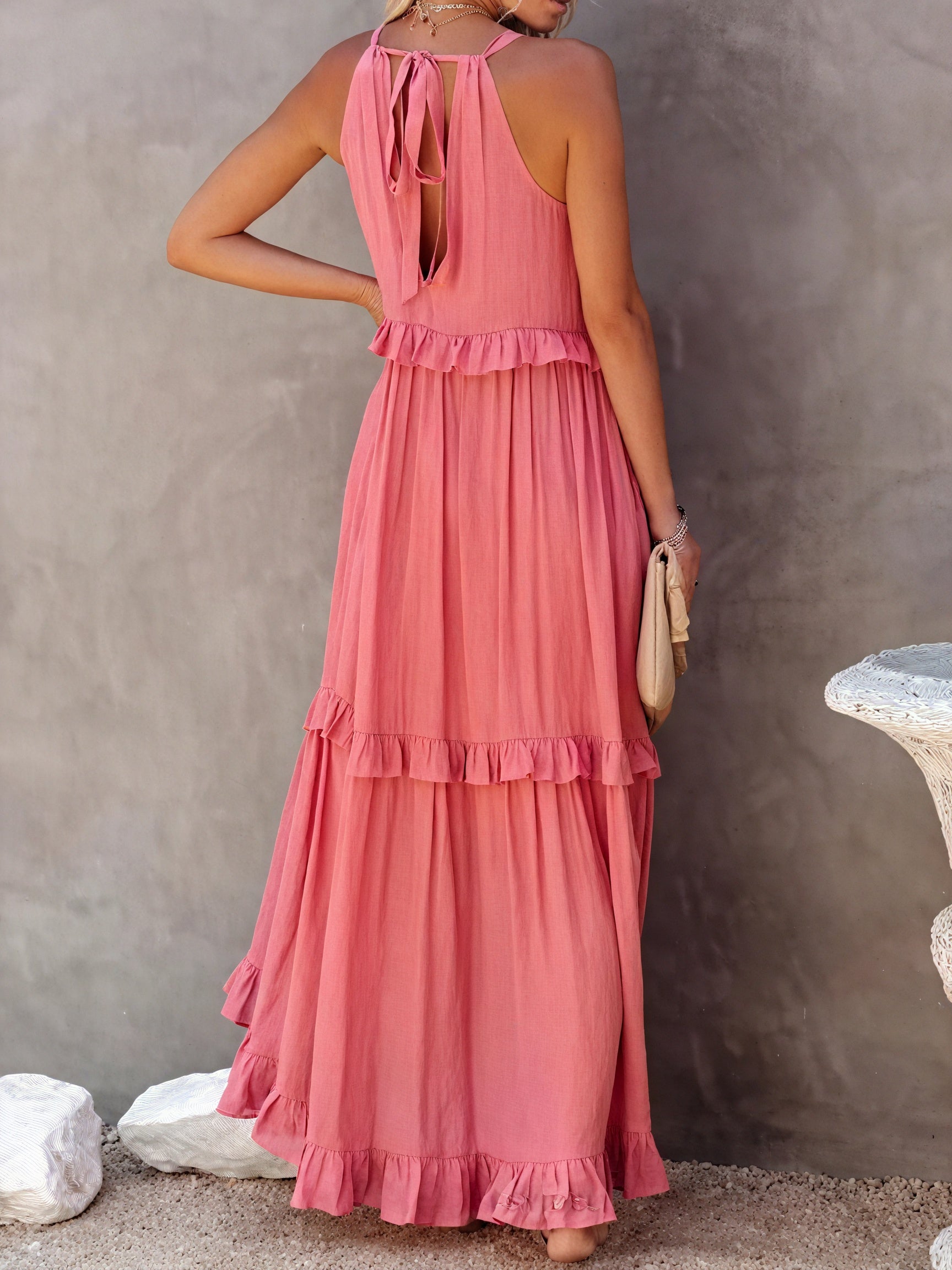 Montaracrest maxi fluid dress with American-style neckline and ruffle details, shown in a flowing fabric.
