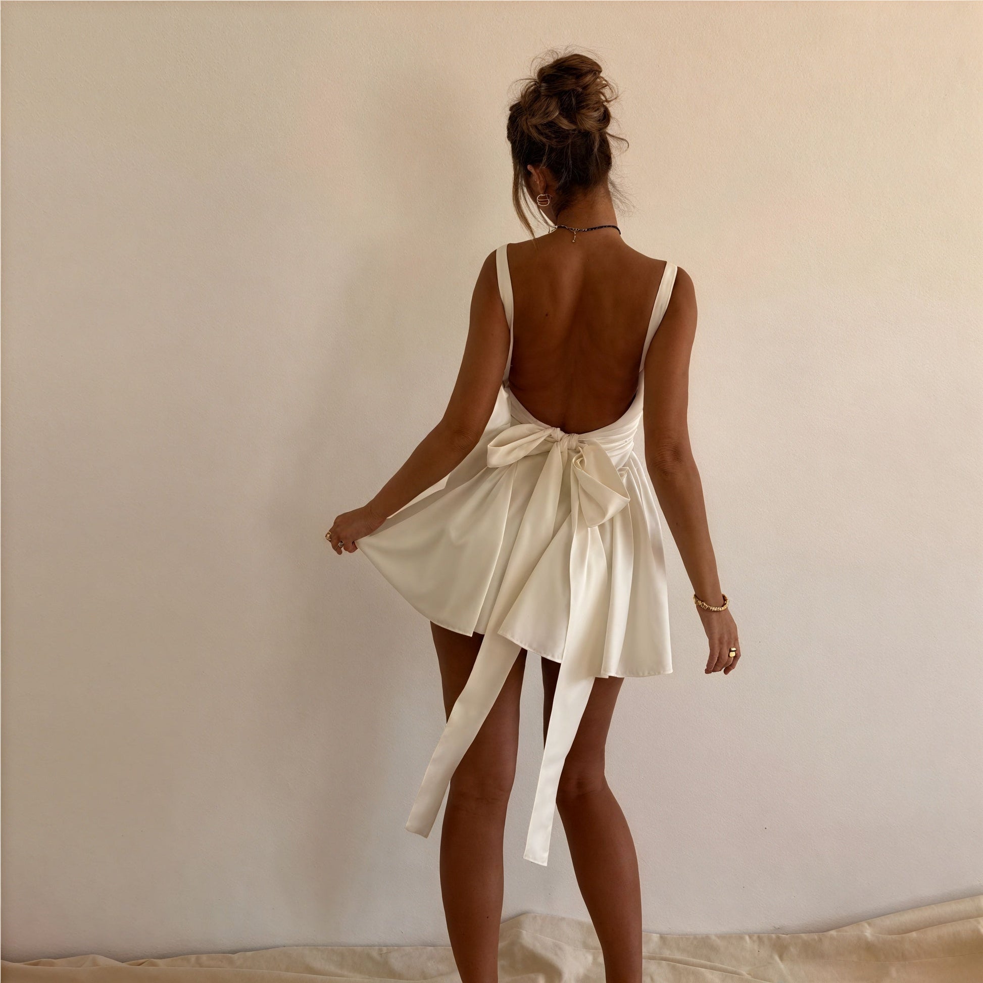 White A-line dress with square neckline and sleeveless design by Montaracrest, featuring a classic, elegant silhouette.