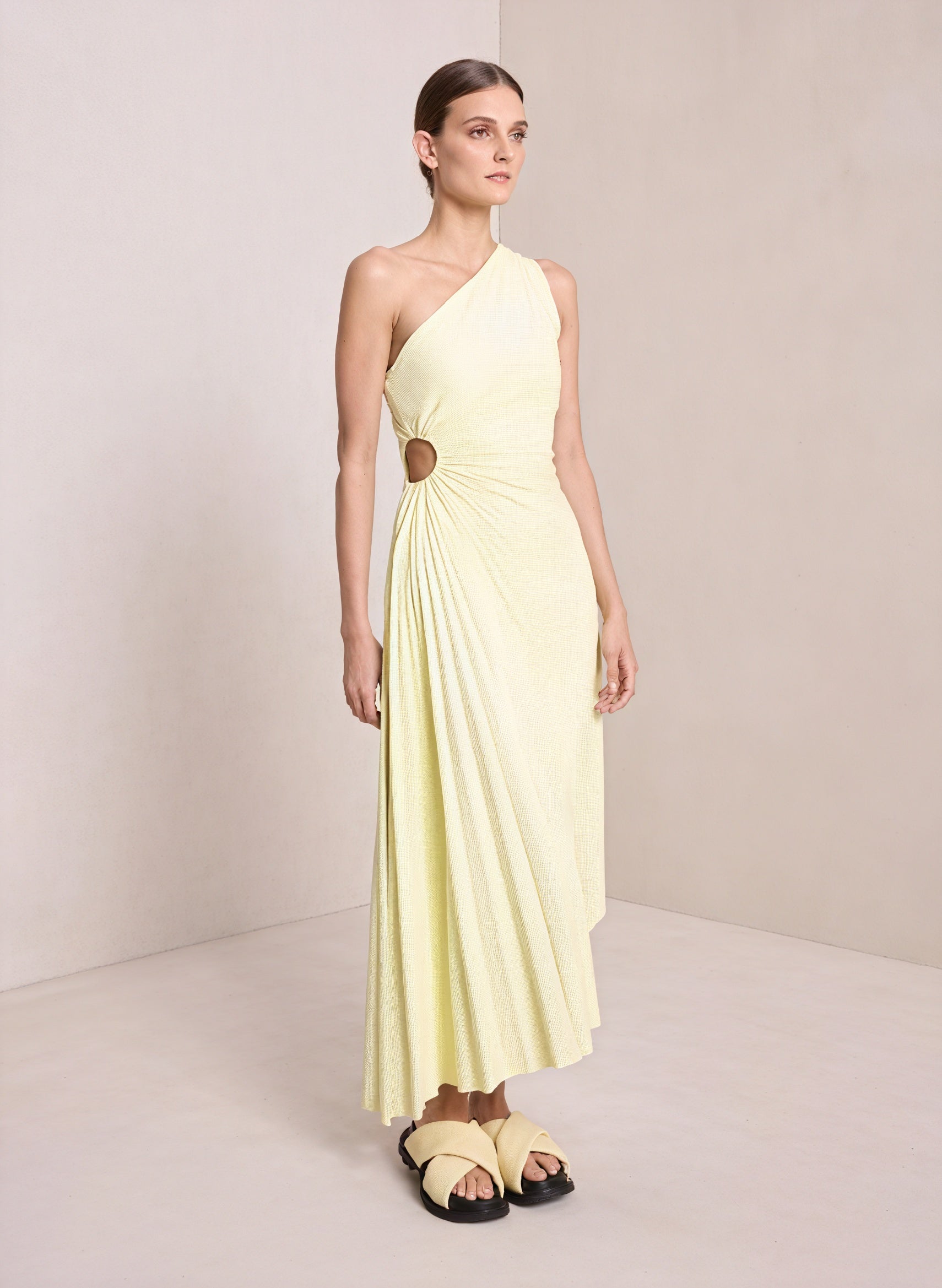 Monospalla pleated dress with asymmetrical hem by Montaracrest, shown in a stylish, flowing design with elegant details.