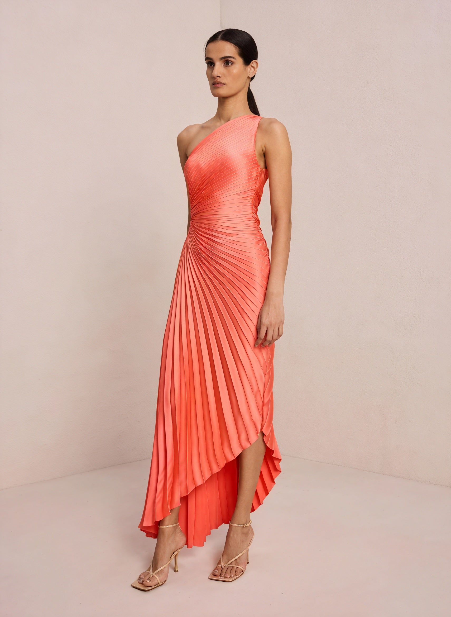 Cream monospalla pleated dress with asymmetric hem from Montaracrest, showcasing the elegant design and flowy fabric.