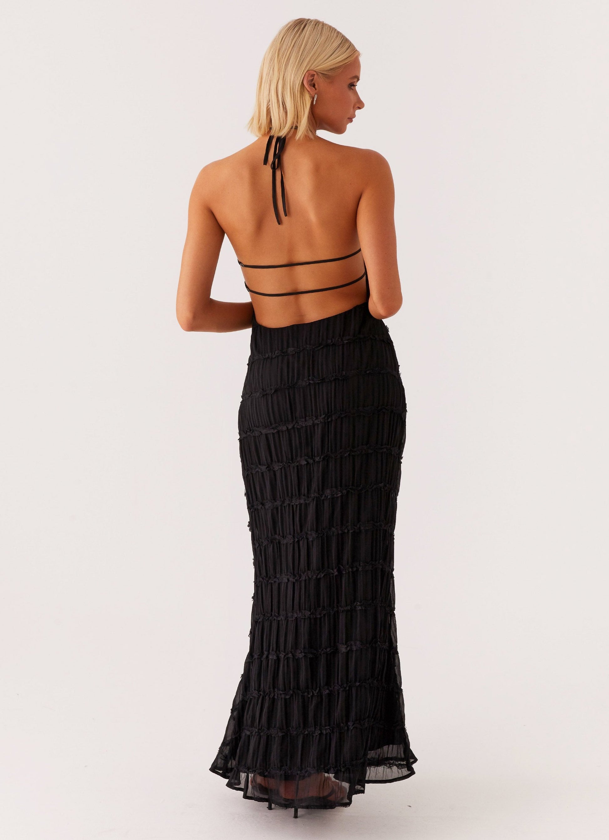 Black Celeste Maxi Dress by Montaracrest featuring a flowing silhouette and elegant design.