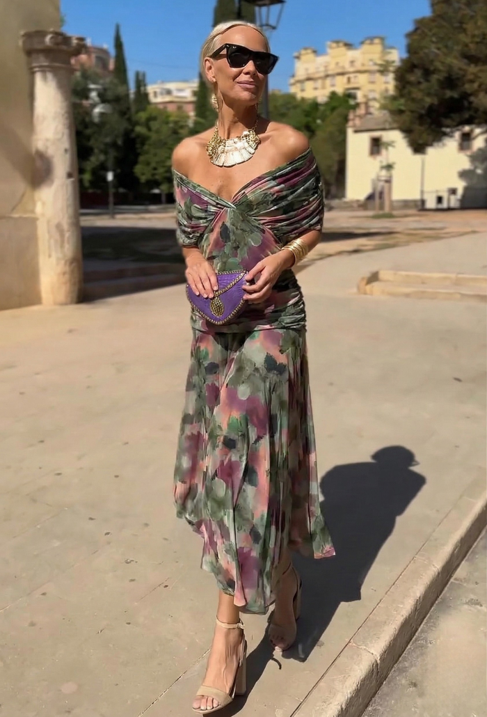 Elegant Montaracrest Luisa long dress with V-neckline highlighting the silhouette, featuring flowing fabric and stylish design.