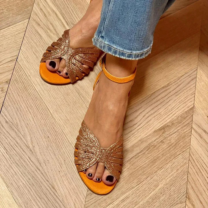 Montaracrest flat sandals with an ankle strap, featuring a sleek design and open toe, perfect for casual summer wear.