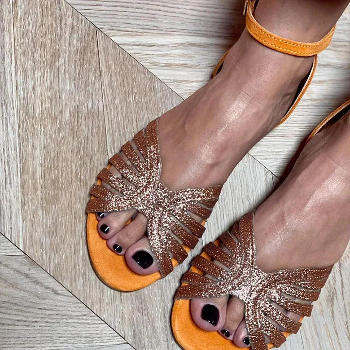 Montaracrest flat sandal with ankle strap and open toe, featuring a sleek design and comfortable fit.