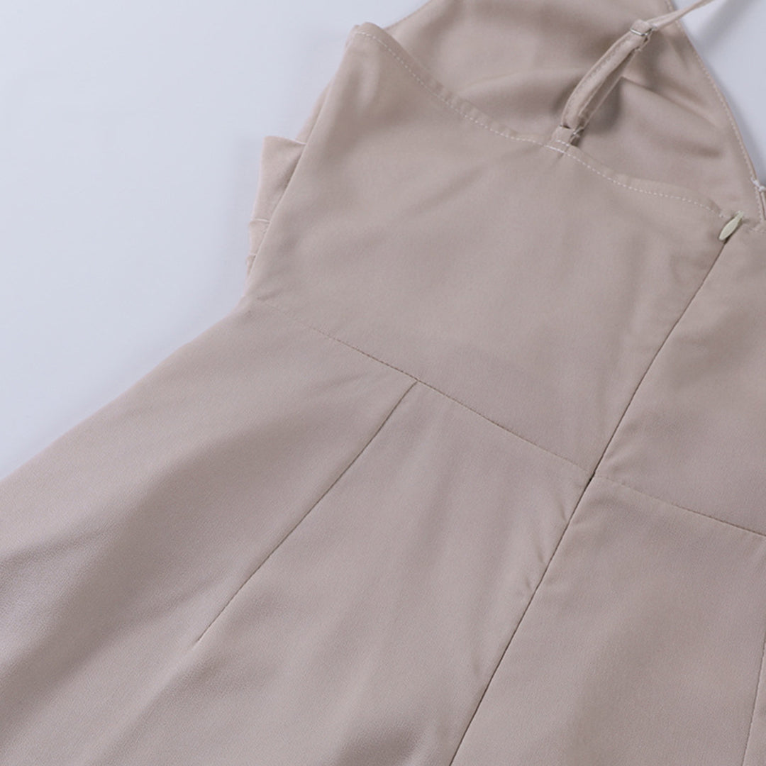 Elegant long slip dress with thigh slit by Montaracrest, featuring smooth fabric and a flowing silhouette.