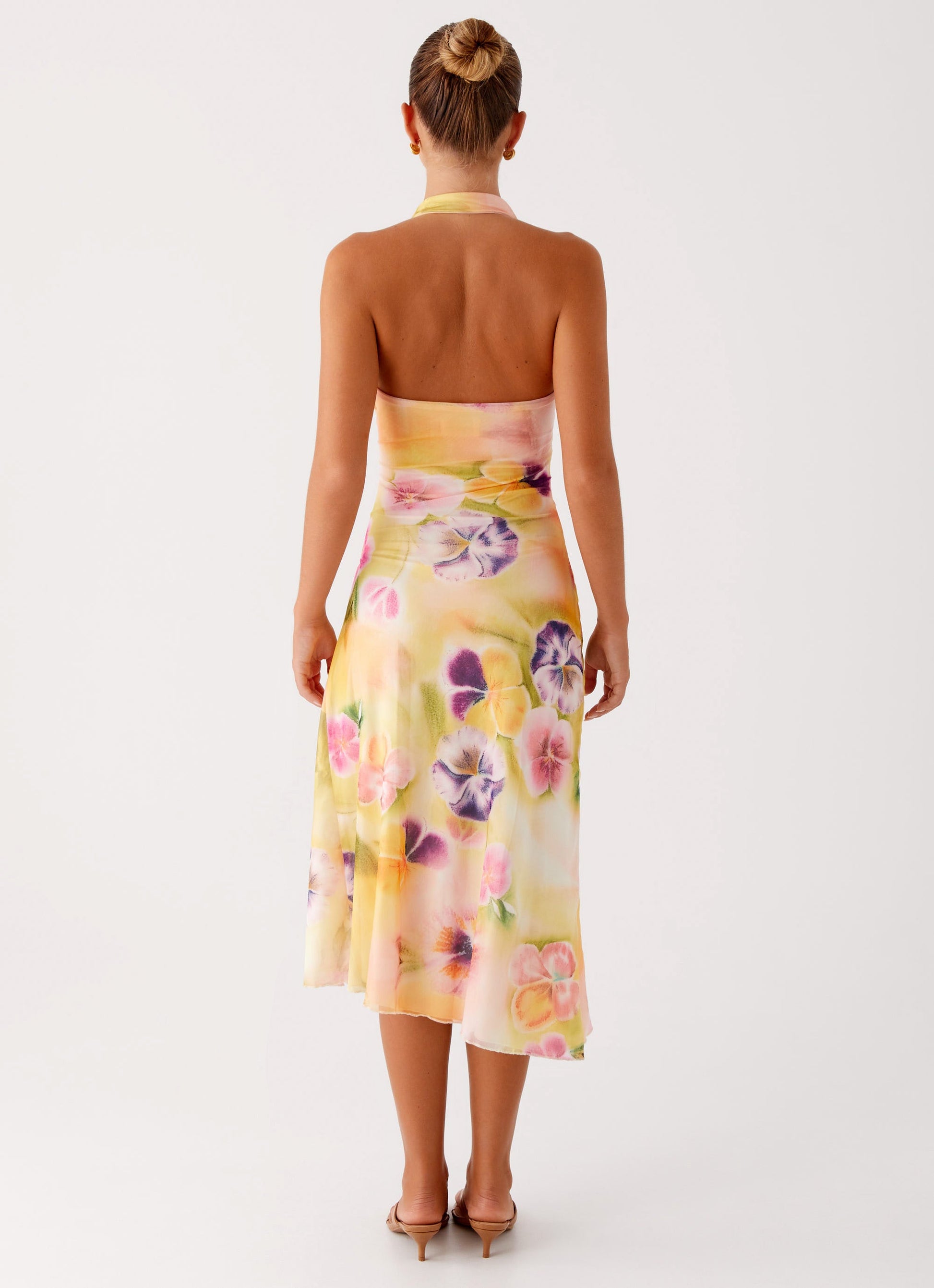 Montaracrest Floral Mirage Midi Dress featuring a vibrant floral pattern and a flowing midi-length silhouette.