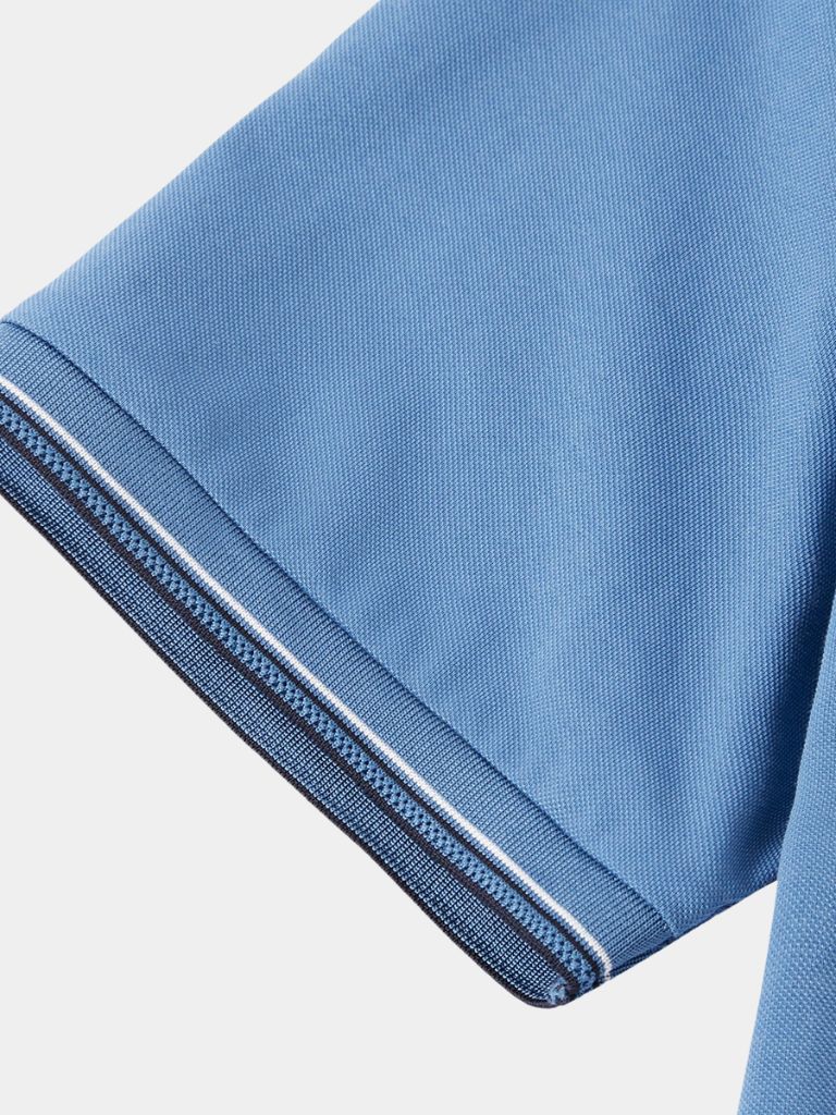 Montaracrest Polo Classica Azure with a classic fit and cross crown design, featuring a sleek blue color and collar detail.