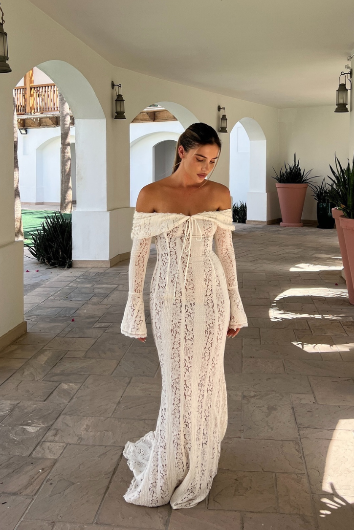 Elegant Montaracrest lace off-shoulder long-sleeve evening dress with intricate detailing and a fitted silhouette.