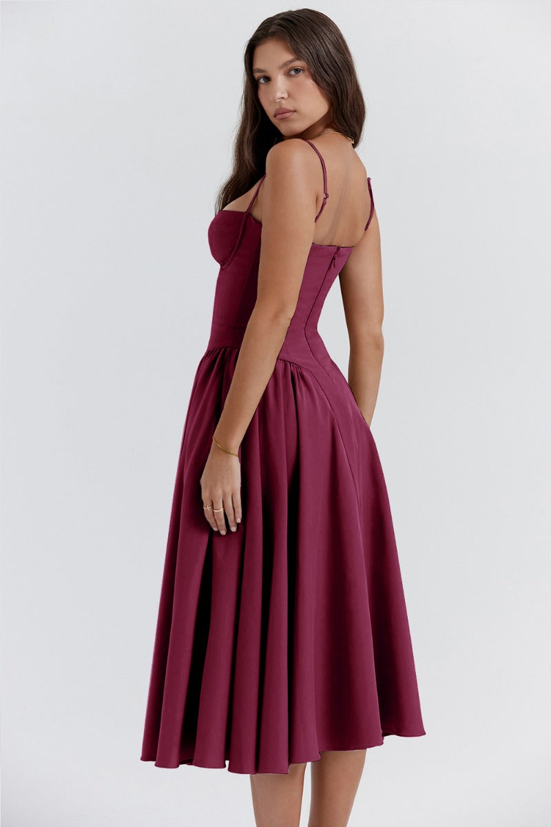 Elegant midi dress by Montaracrest with pleated design, structured bodice, and functional pockets on the skirt.