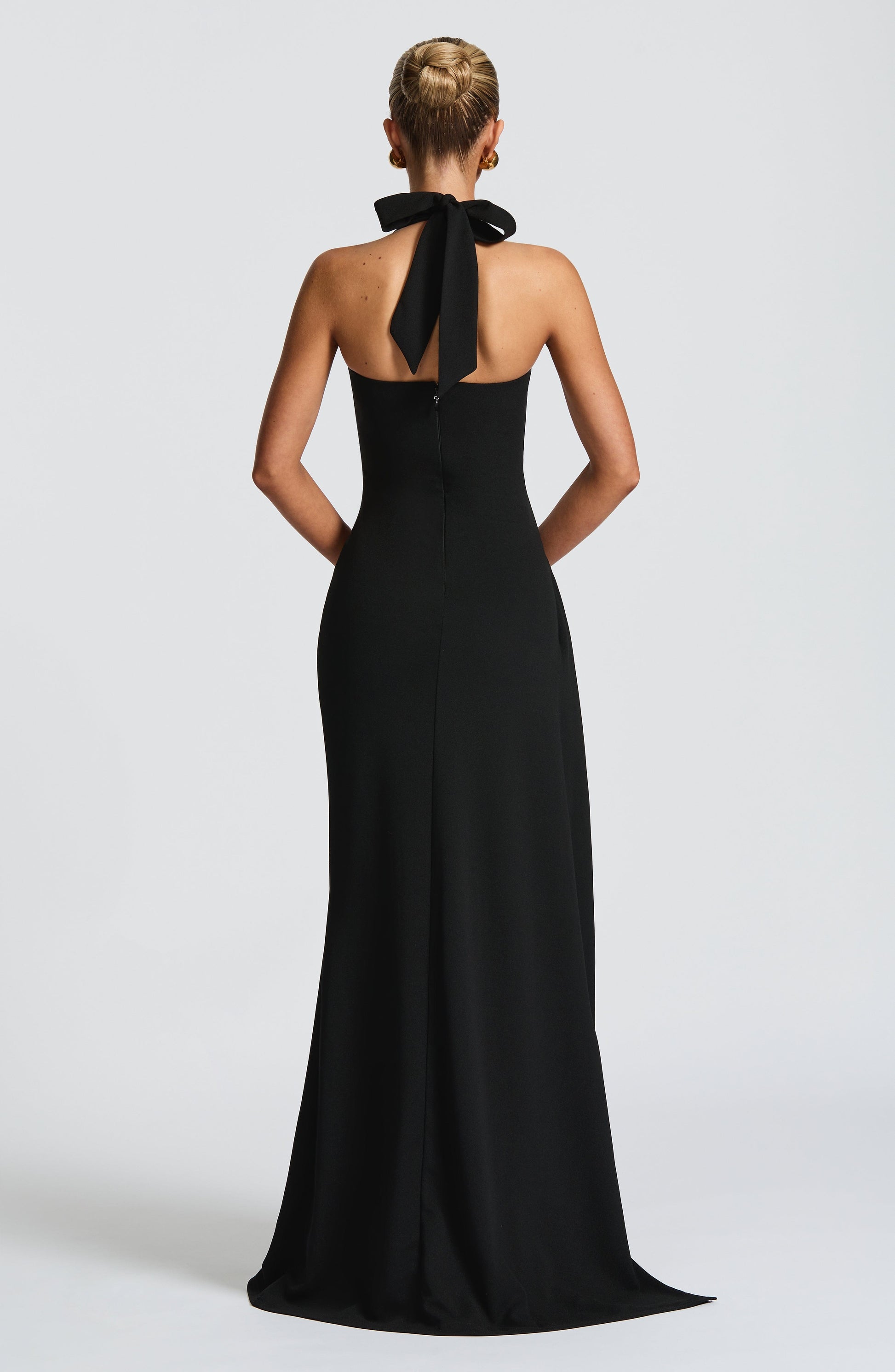 Black Enchant Maxi Dress by Montaracrest, flowing fabric, elegant design, shown on a model. Perfect for formal occasions.