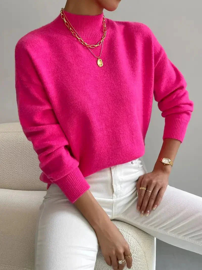 Elegant Montaracrest Seraphine high-neck wool sweater worn by a woman, showcasing cozy, stylish knitwear.