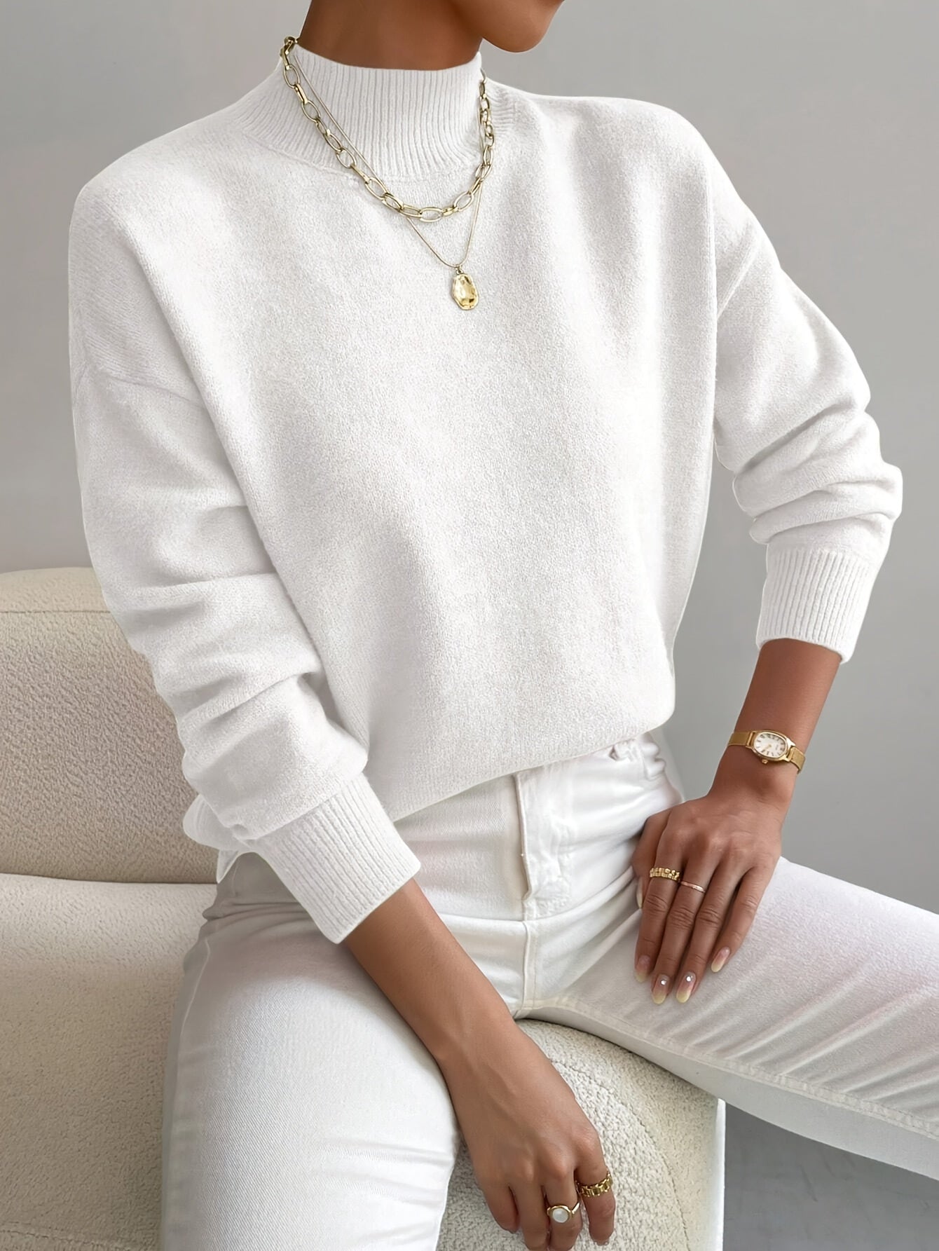 Elegant Montaracrest Seraphine high-neck sweater worn by a woman, showcasing a comfortable and stylish knit design.