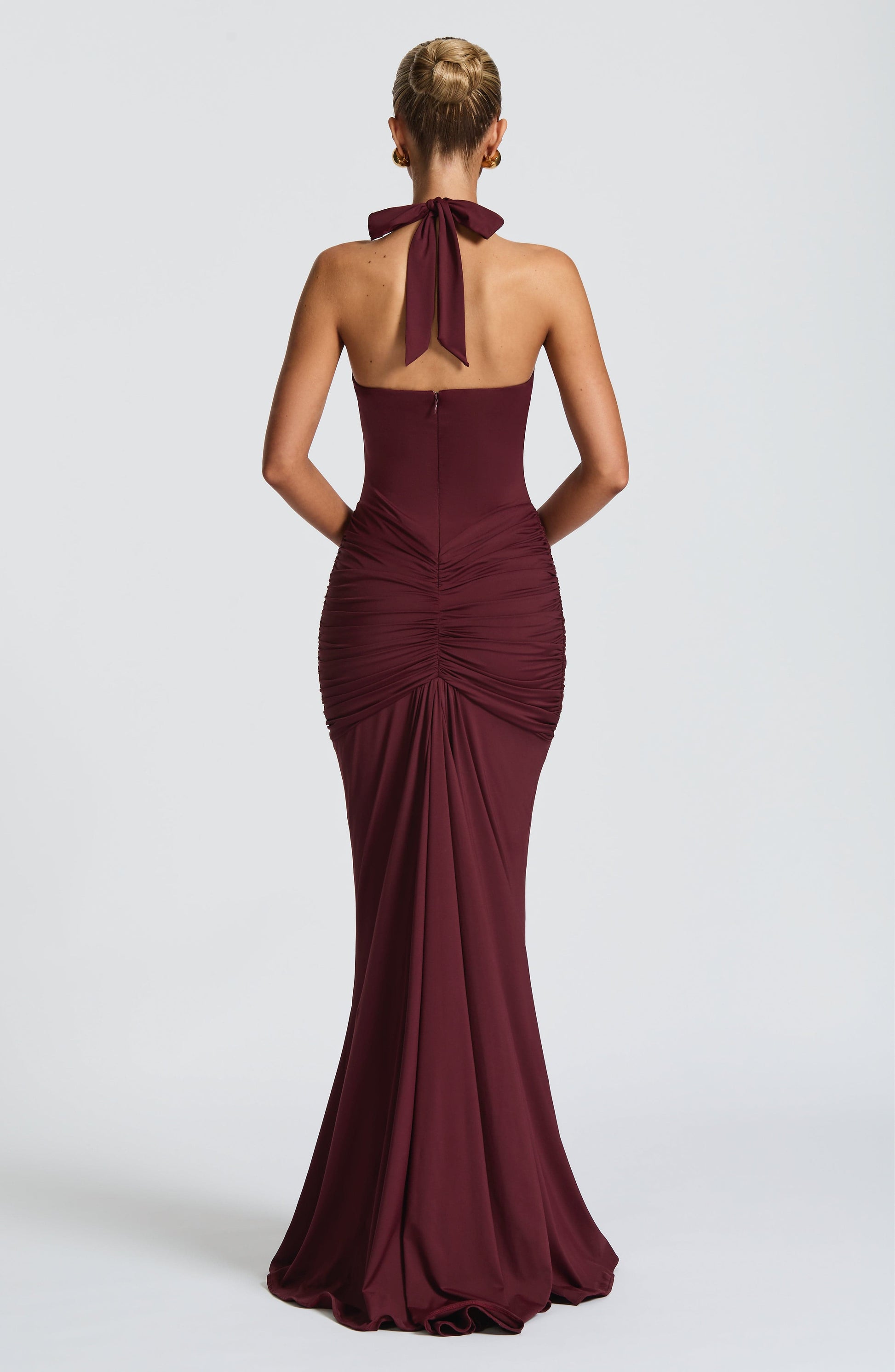 Montaracrest Freja halterneck dress in cherry lacquer color, featuring a flowing maxi design with elegant details.